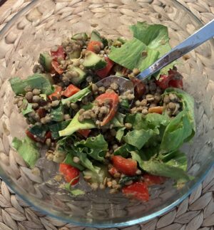 salad with brown lentils, red bell pepper, cucumber, creamy peanut tahini dressing,